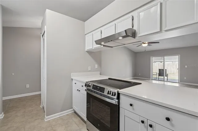 a kitchen with cabinets and a stove top oven