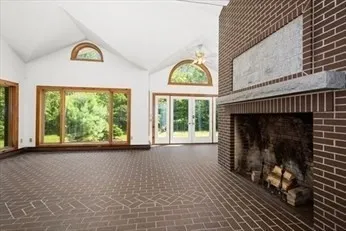 a view of empty room with a fireplace