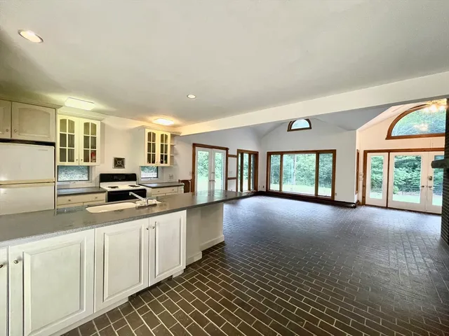a view of a bedroom with furniture and large windows