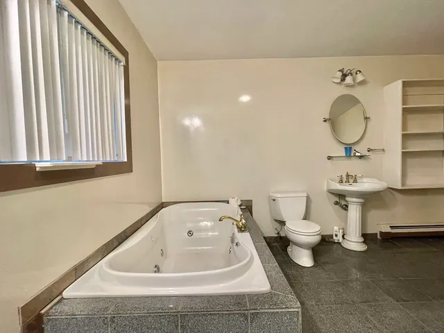 a bathroom with a sink mirror and a toilet