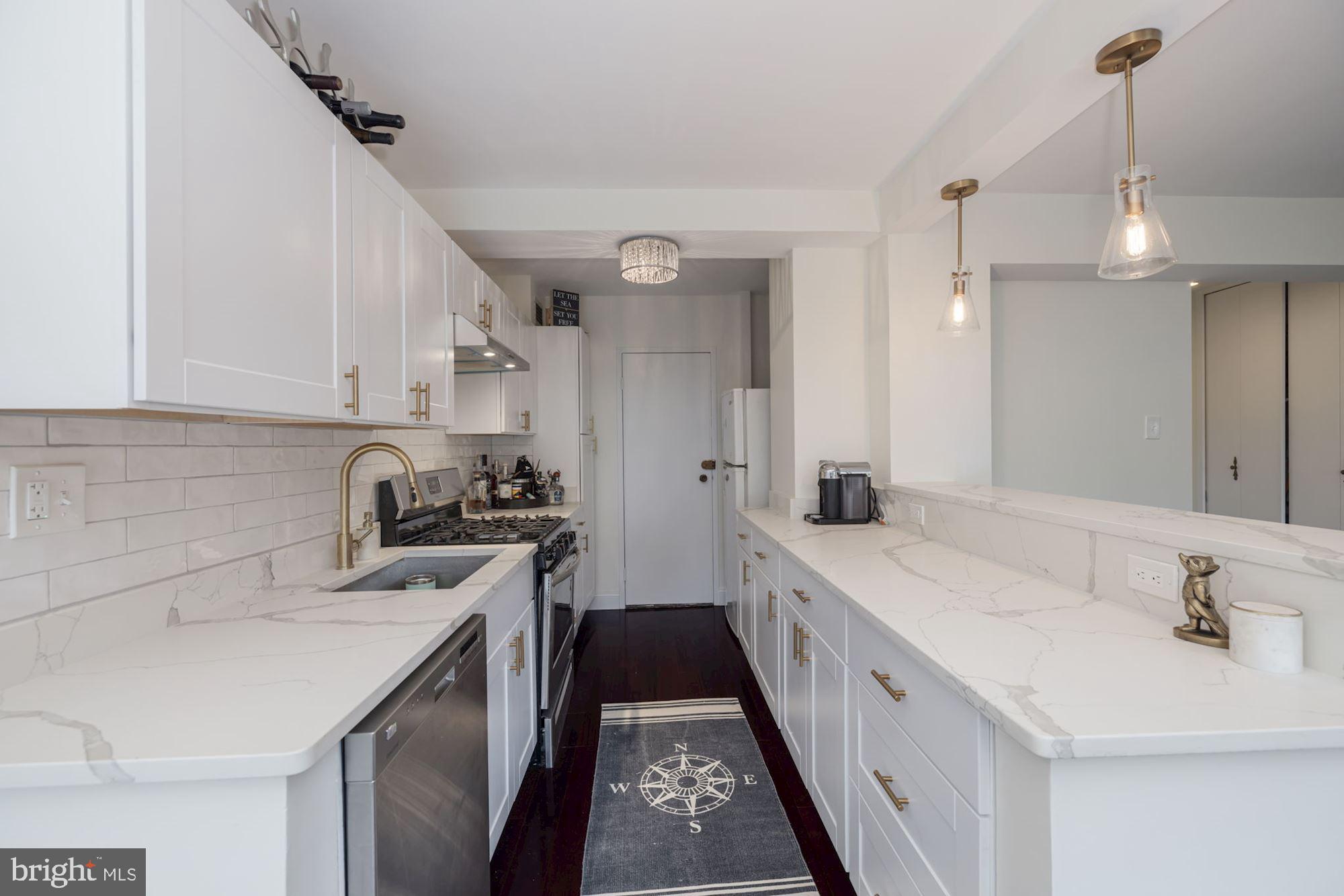 a kitchen with a sink stove and refrigerator
