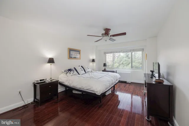 a bedroom with a bed and a flat tv screen on the dresser