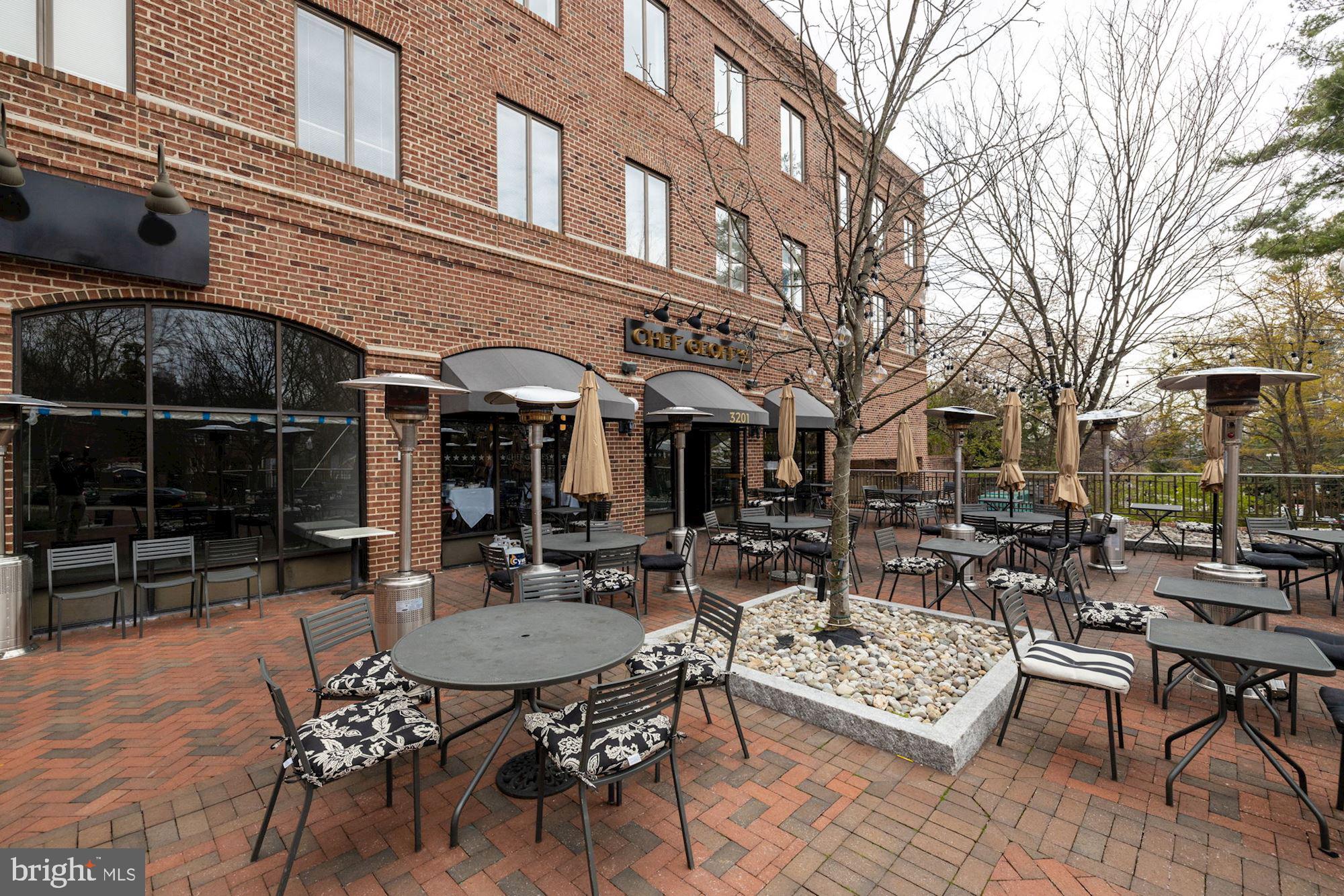4201 Cathedral Avenue Northwest, Unit 620E Washington, DC 20016 - Photo 24 of 28 a view of a patio with couches table and chairs and potted plants