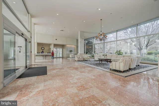 a lobby with furniture and a chandelier