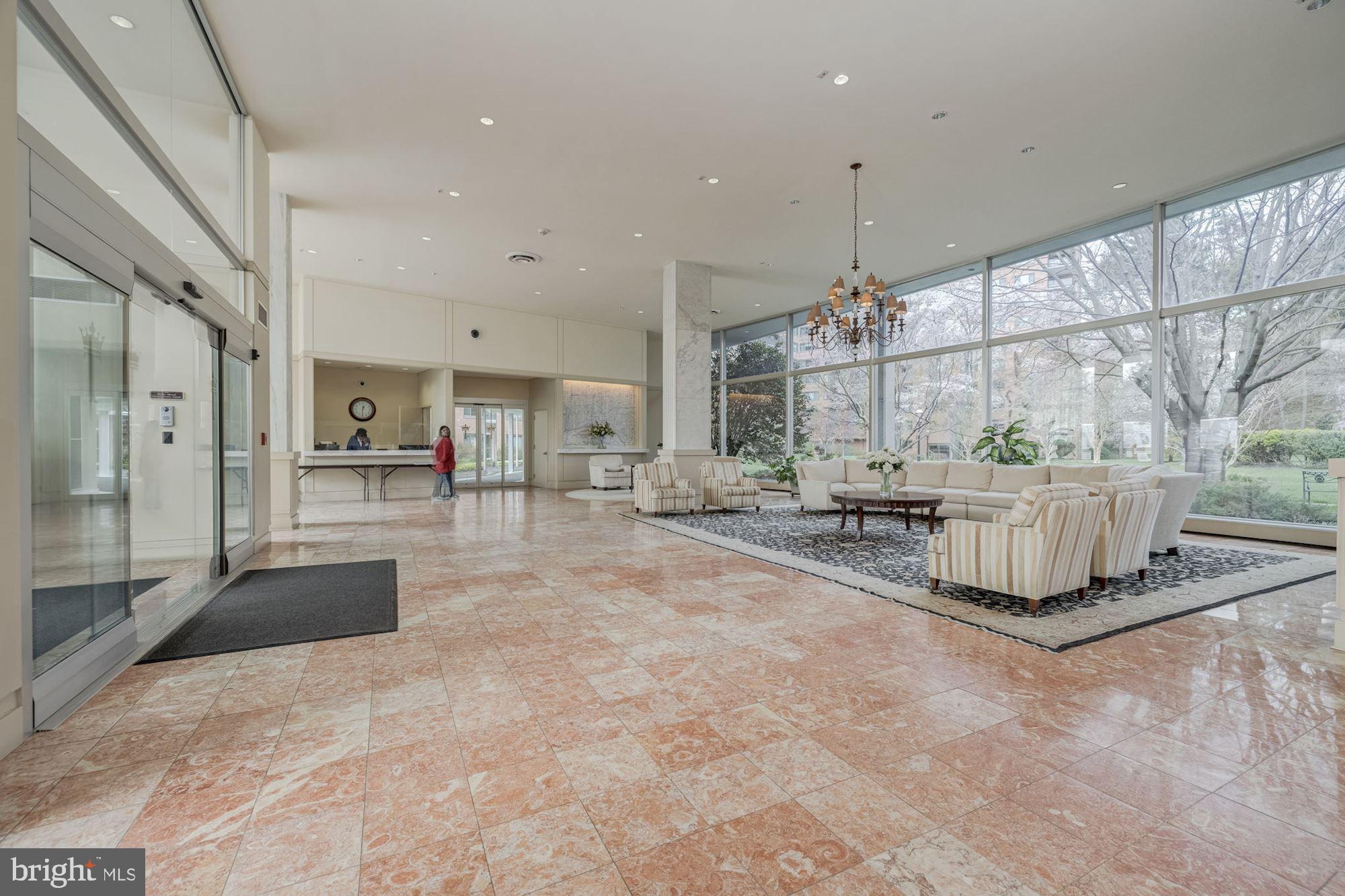 4201 Cathedral Avenue Northwest, Unit 620E Washington, DC 20016 - Photo 4 of 28 a lobby with furniture and a chandelier