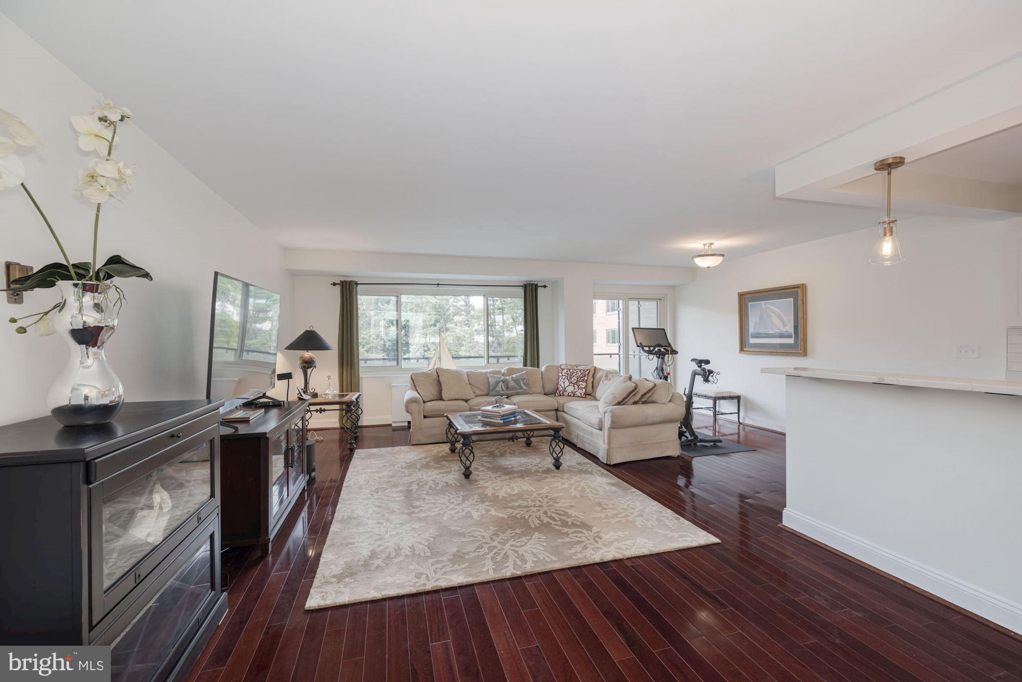 4201 Cathedral Avenue Northwest, Unit 620E Washington, DC 20016 - Photo 6 of 28 a living room with furniture and a wooden floor