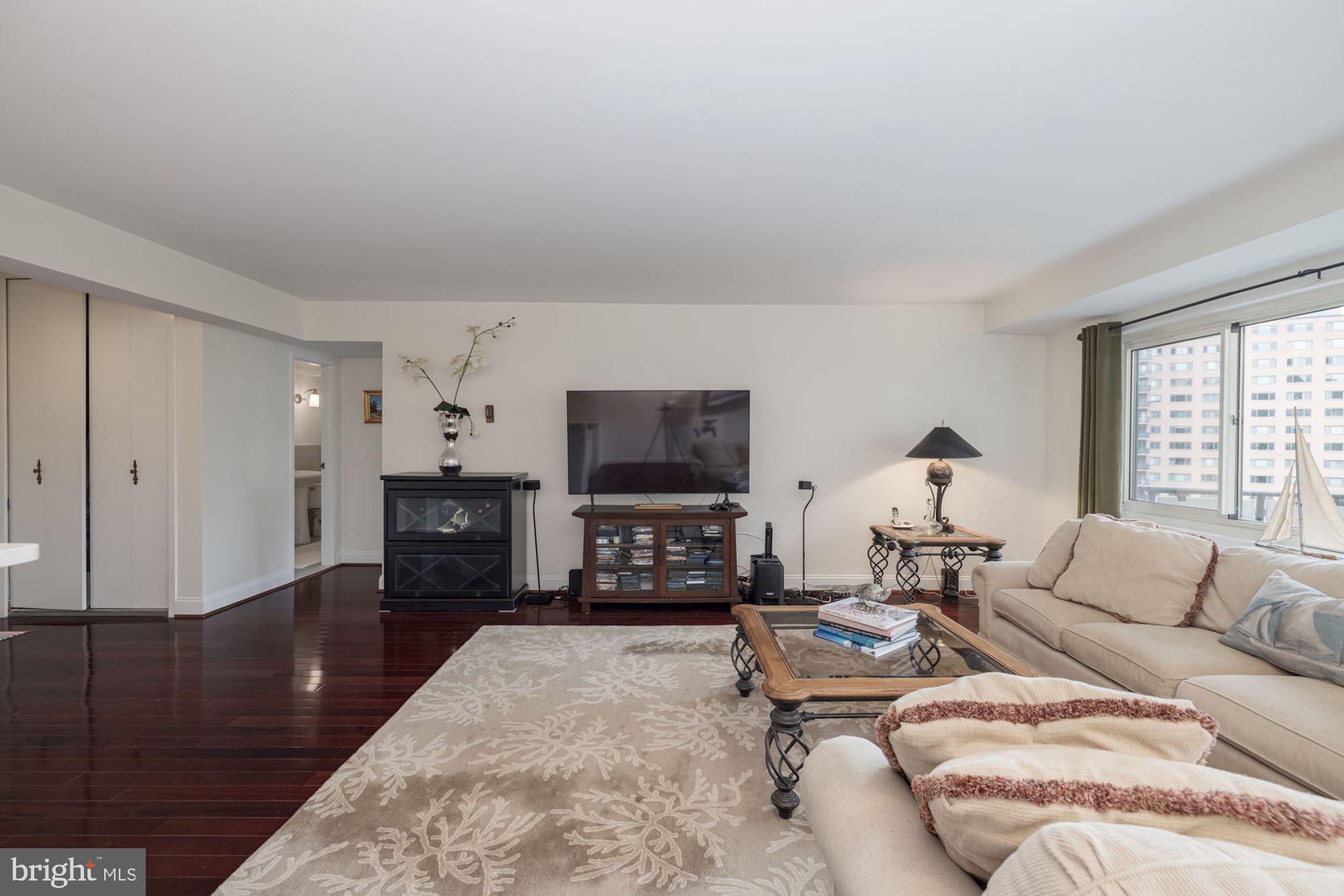4201 Cathedral Avenue Northwest, Unit 620E Washington, DC 20016 - Photo 8 of 28 a living room with furniture and a flat screen tv