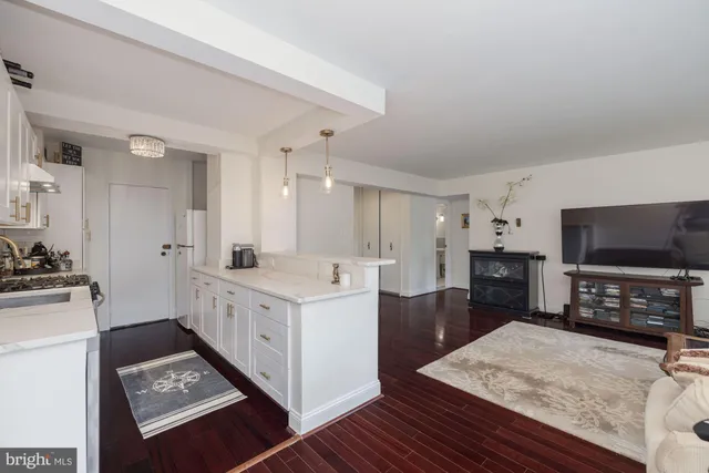 a kitchen with white cabinets and appliances