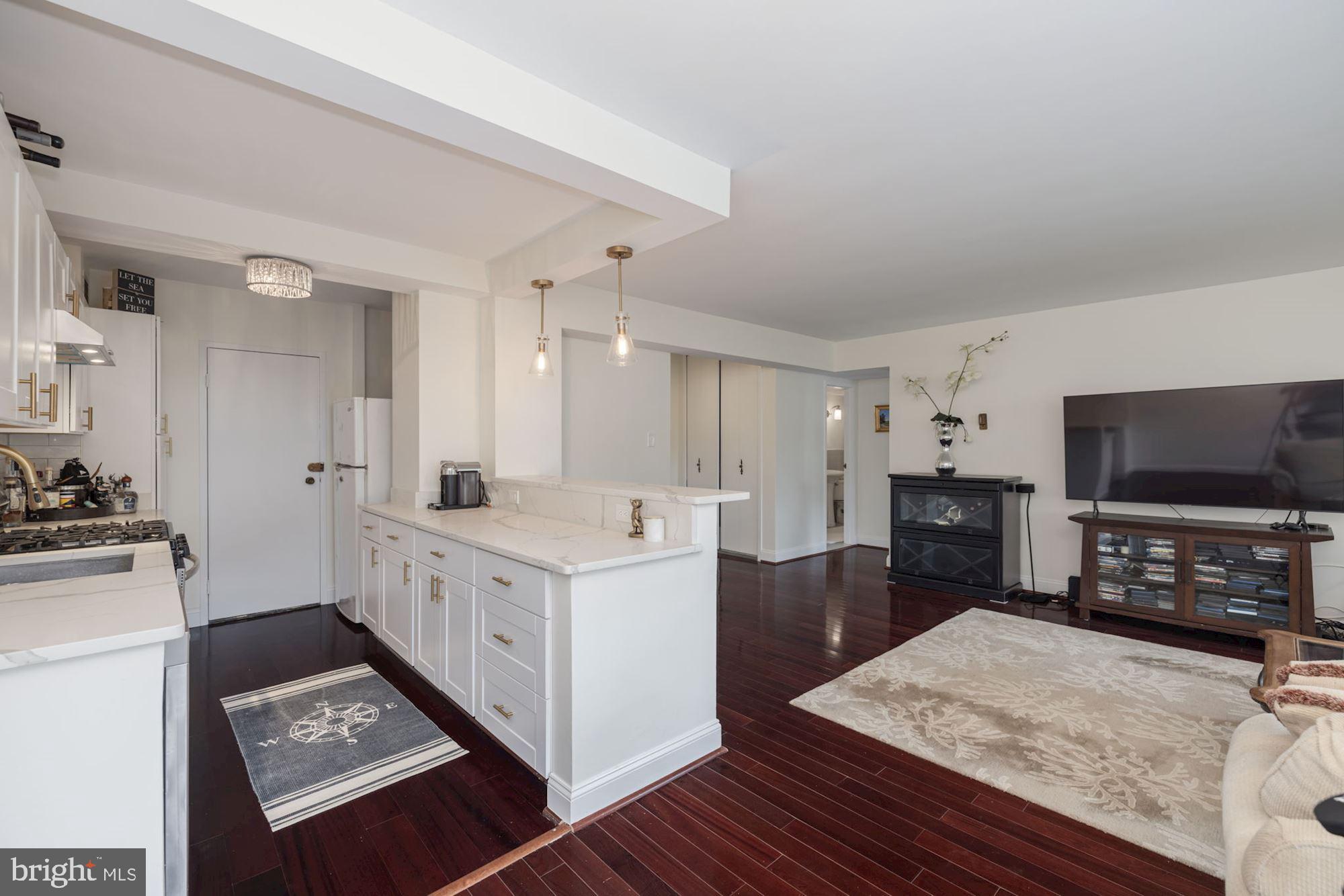 4201 Cathedral Avenue Northwest, Unit 620E Washington, DC 20016 - Photo 9 of 28 a open kitchen with sink cabinets and refrigerator