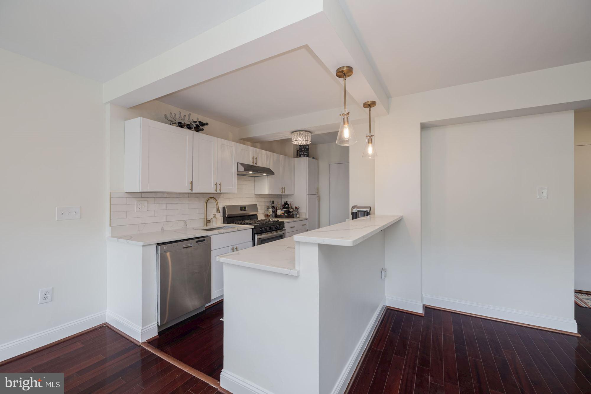 4201 Cathedral Avenue Northwest, Unit 620E Washington, DC 20016 - Photo 10 of 28 a kitchen with white cabinets and appliances