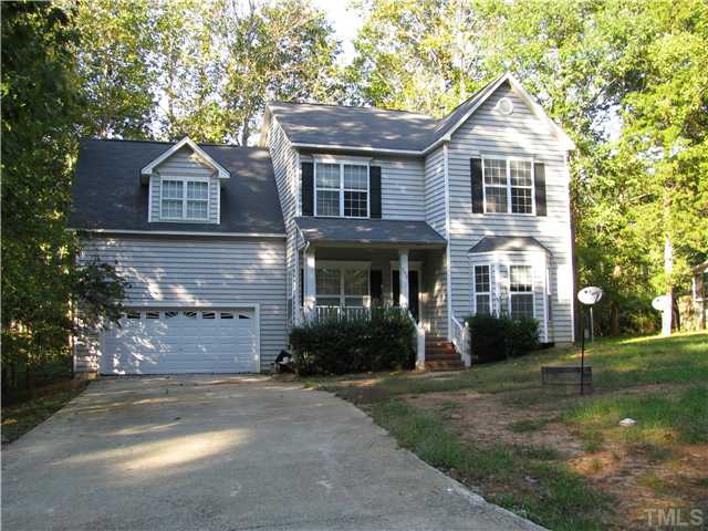 808 Kings Cross Way Raleigh, NC 27615 - Photo 1 of 6 a front view of a house with a yard and garage