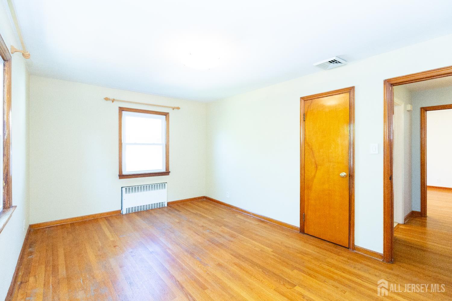 2624 Tremley Point Road Linden, NJ 07036 - Photo 18 of 43 an empty room with wooden floor and closet