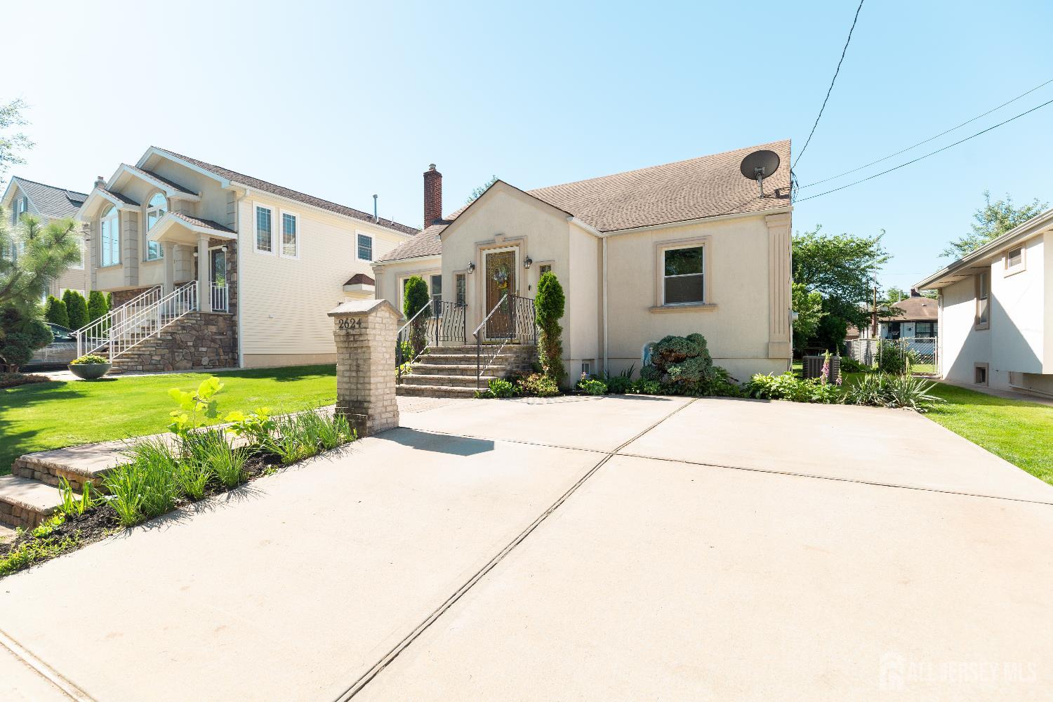 2624 Tremley Point Road Linden, NJ 07036 - Photo 2 of 43 a front view of a house with a yard and potted plants