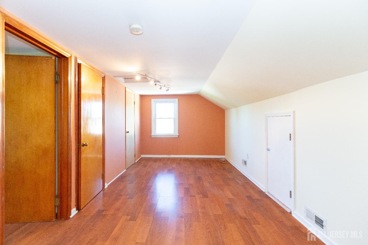 2624 Tremley Point Road Linden, NJ 07036 - Photo 28 of 43 a view of an empty room with wooden floor and a window