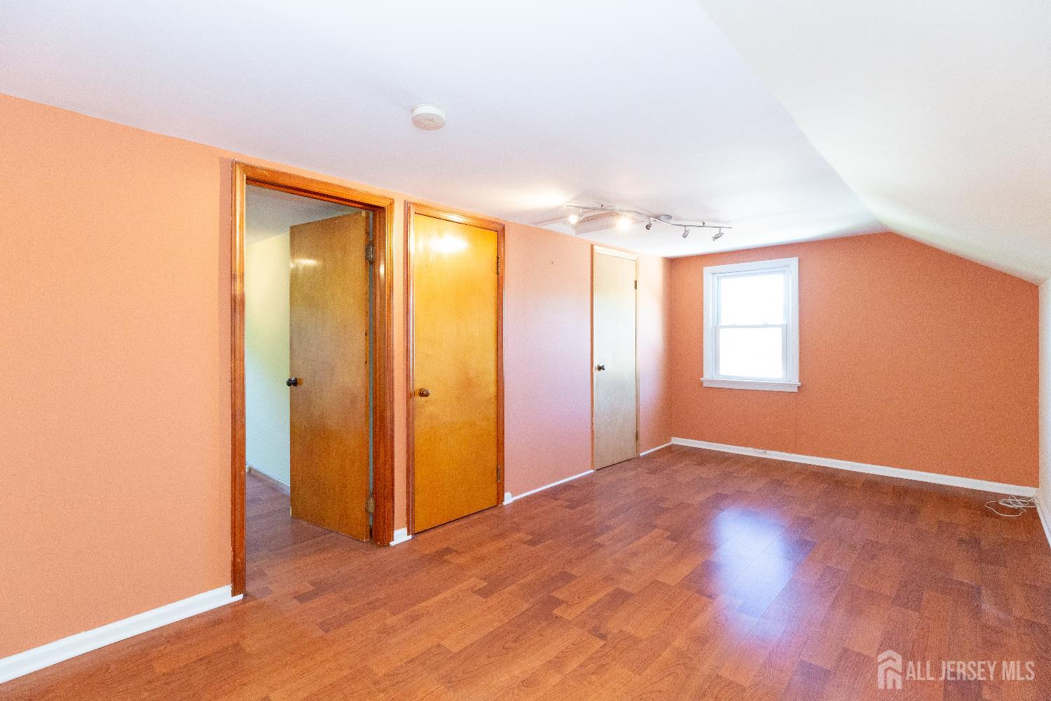 2624 Tremley Point Road Linden, NJ 07036 - Photo 29 of 43 a view of an empty room with window and wooden floor