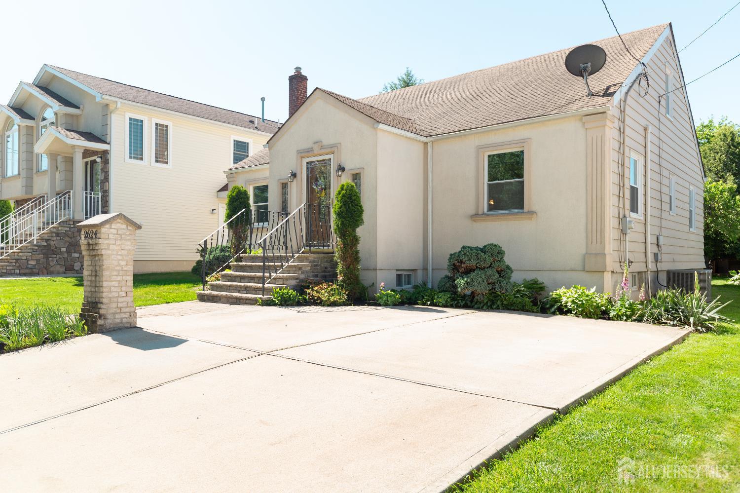 2624 Tremley Point Road Linden, NJ 07036 - Photo 3 of 43 a front view of a house with garden