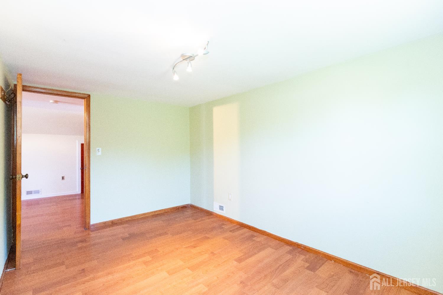 2624 Tremley Point Road Linden, NJ 07036 - Photo 35 of 43 an empty room with wooden floor and windows