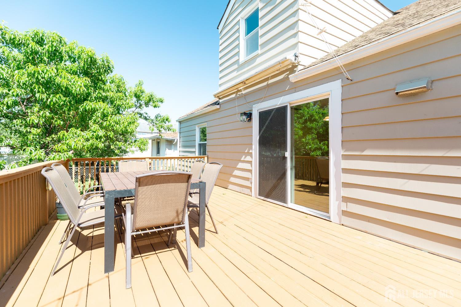 2624 Tremley Point Road Linden, NJ 07036 - Photo 42 of 43 a view of a patio with table and chairs with wooden floor and fence