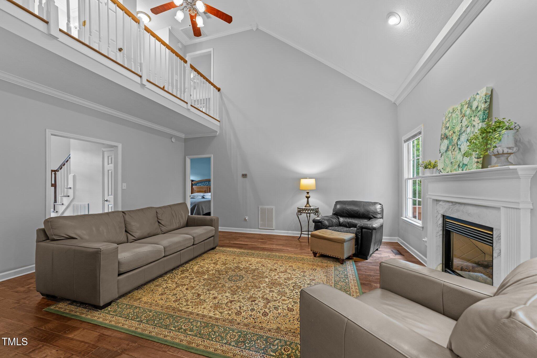 1245 Torchlight Way Raleigh, NC 27603 - Photo 7 of 47 Living room has high ceilings and cozy fireplace.