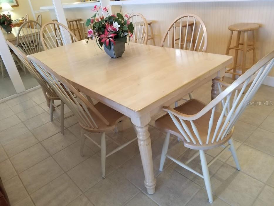 13650 Gulf Boulevard, Unit 304 Madeira Beach, FL 33708 - Photo 28 of 63 a view of a dining room with furniture and wooden floor