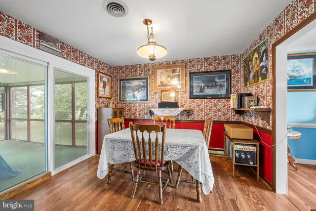 a view of an empty room with large windows