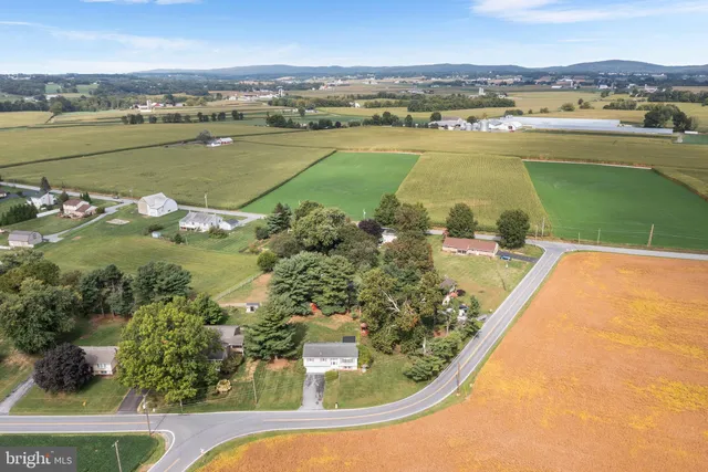 an aerial view of a house with a lake view