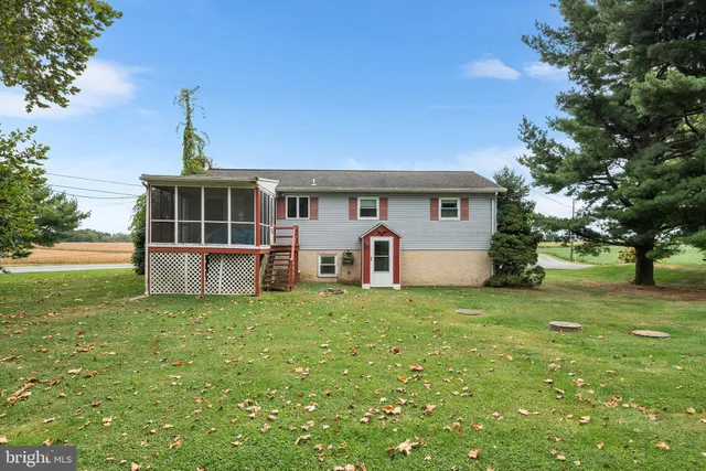 a work room with furniture and a book shelf