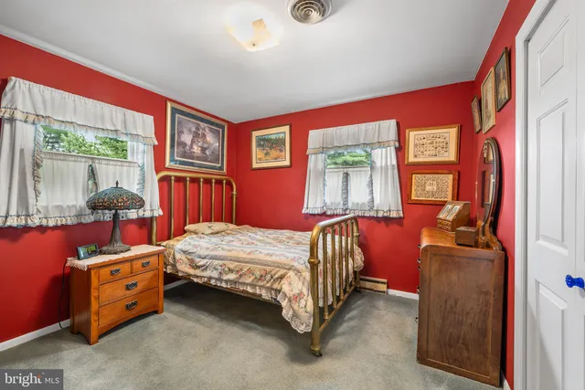 a bathroom with a sink a toilet a mirror a vanity and shower
