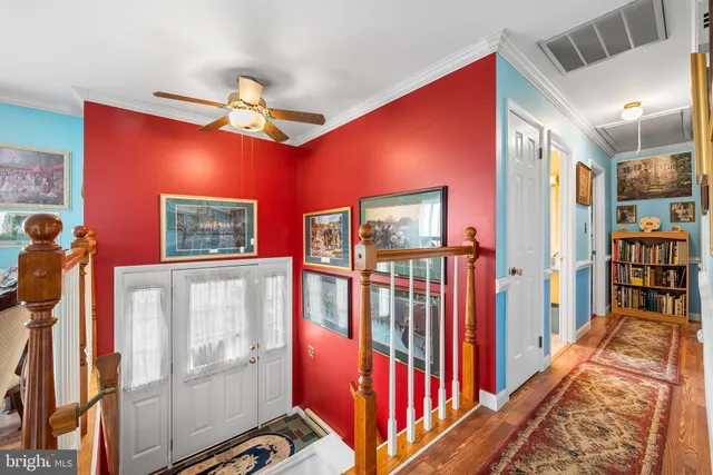a view of a dining room with furniture a chandelier and wooden floor