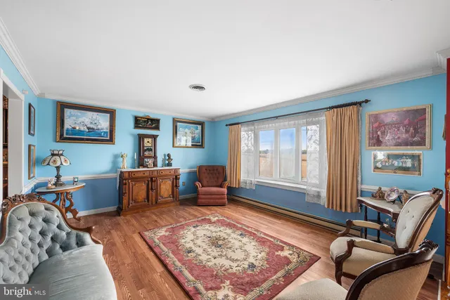 a living room with furniture a rug and a floor to ceiling window