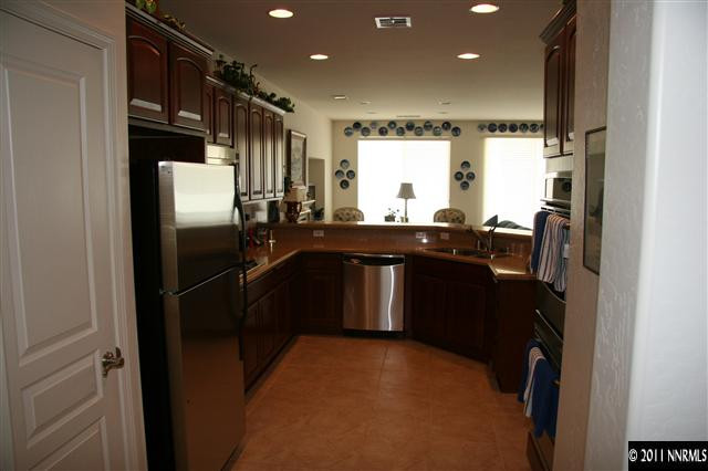1335 Meridian Ranch Drive Reno, NV 89523 - Photo 3 of 7 a kitchen with a sink refrigerator and cabinets