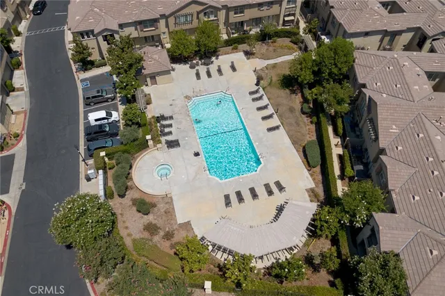 an aerial view of a house with a yard and swimming pool
