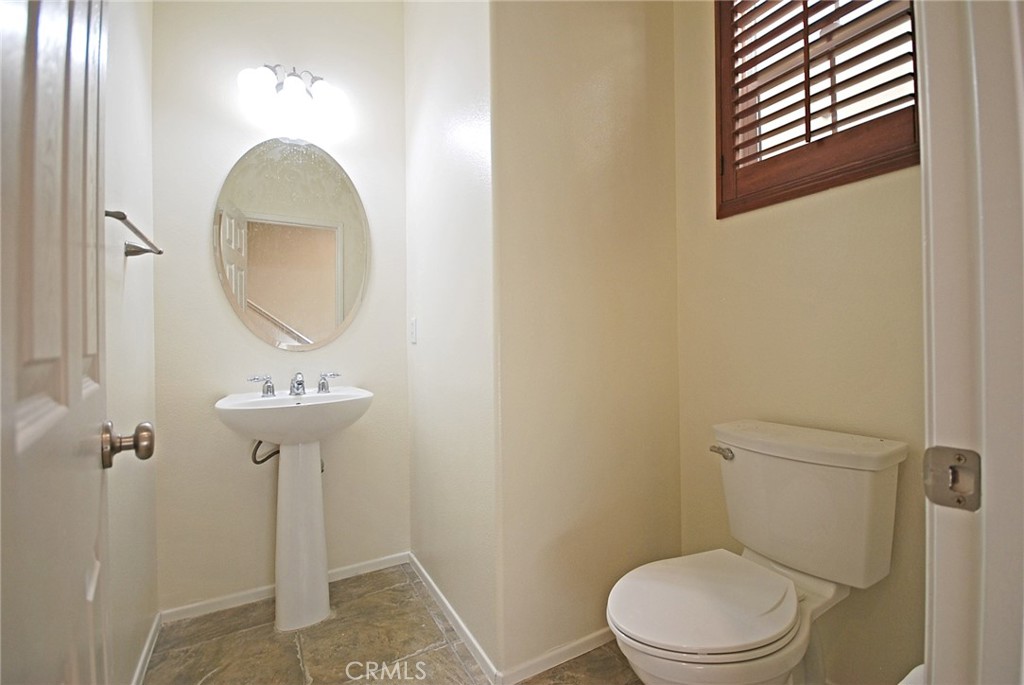 25209 Bishop Court Stevenson Ranch, CA 91381 - Photo 7 of 19 a bathroom with a toilet sink and vanity