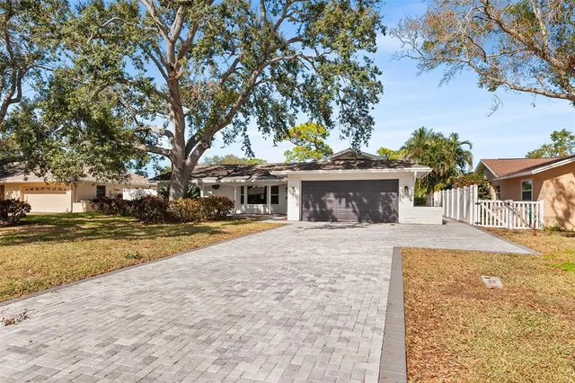 a front view of a house with a yard and a garage