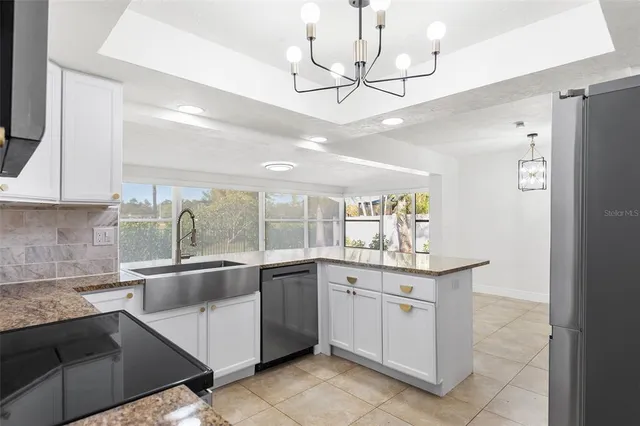 a kitchen with a sink counter top space appliances and cabinets