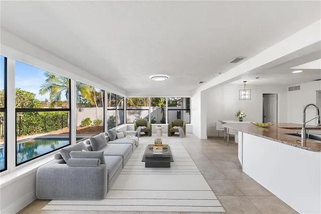 a living room with furniture and large windows