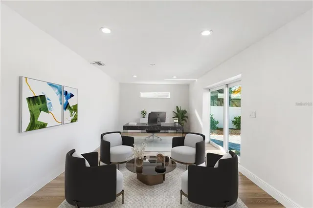a living room with furniture potted plant and a large window