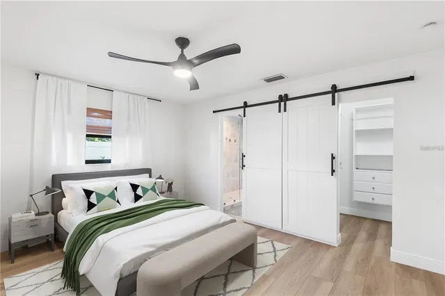 a bedroom with a bed and wooden floor