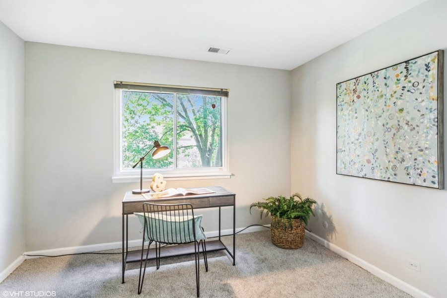 545 Greystone Lane, Unit A2 Wheeling, IL 60090 - Photo 13 of 21 a workspace with furniture and a potted plant