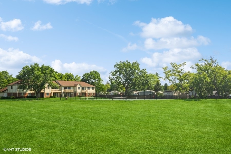 545 Greystone Lane, Unit A2 Wheeling, IL 60090 - Photo 18 of 21 a view of a house with a big yard