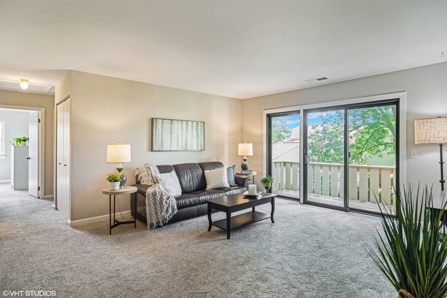 545 Greystone Lane, Unit A2 Wheeling, IL 60090 - Photo 2 of 21 a living room with furniture and a large window