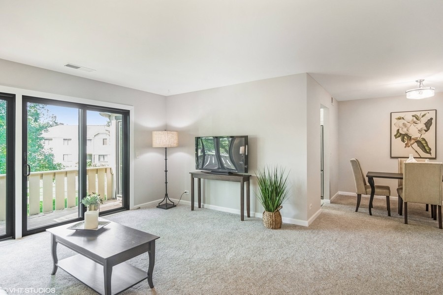 545 Greystone Lane, Unit A2 Wheeling, IL 60090 - Photo 3 of 21 a living room with furniture and large windows