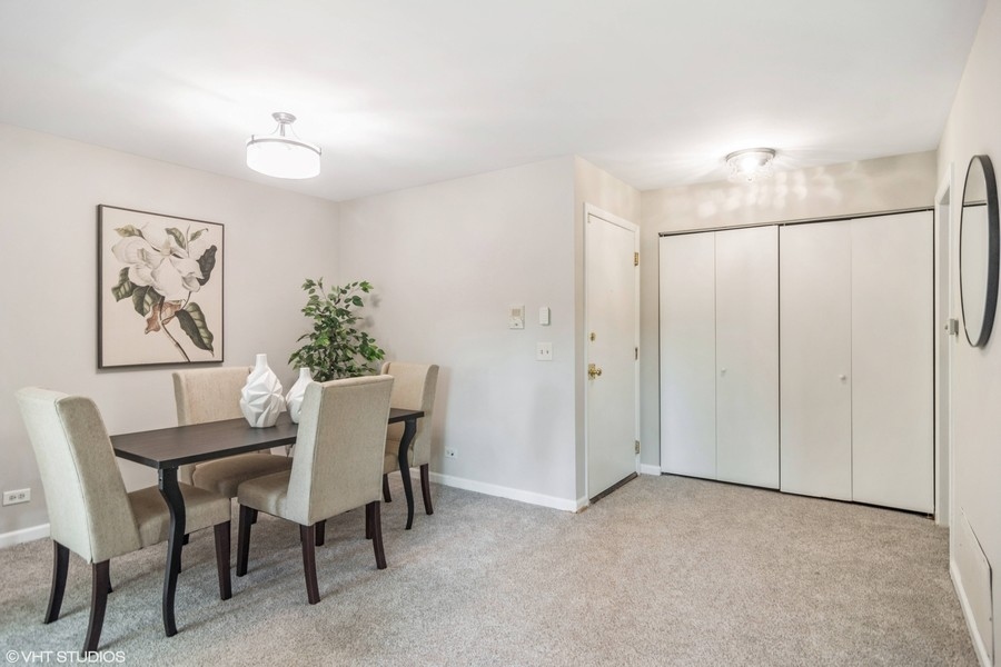 545 Greystone Lane, Unit A2 Wheeling, IL 60090 - Photo 9 of 21 a dining room with furniture and window