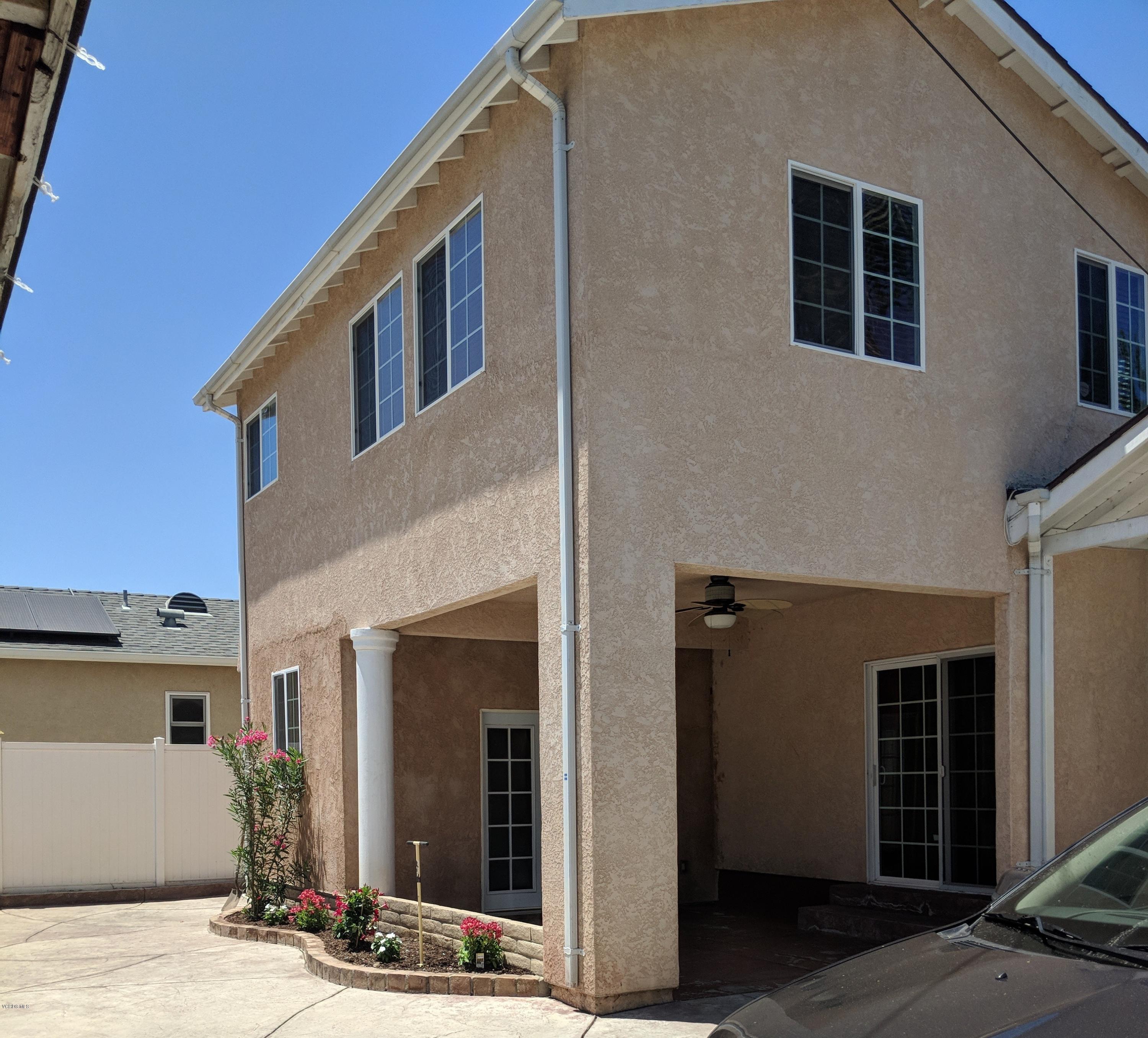19518 Hart Street Reseda, CA 91335 - Photo 2 of 16 a front view of a house with a yard