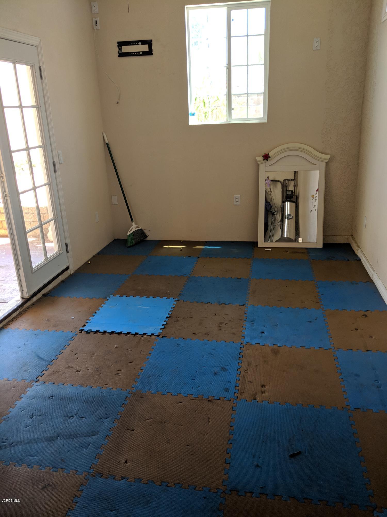 19518 Hart Street Reseda, CA 91335 - Photo 12 of 16 an empty room with wooden floor and windows