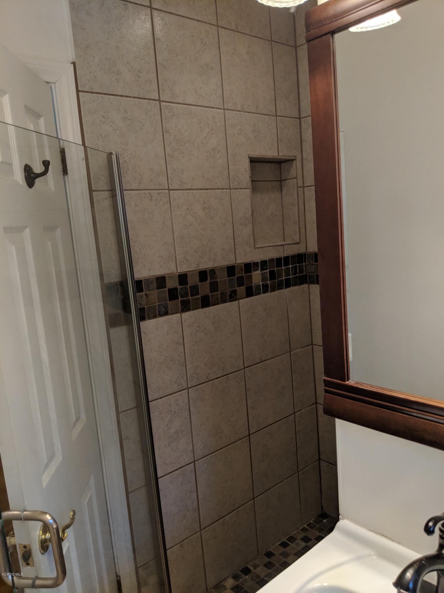 19518 Hart Street Reseda, CA 91335 - Photo 13 of 16 a bathroom with a shower and a toilet