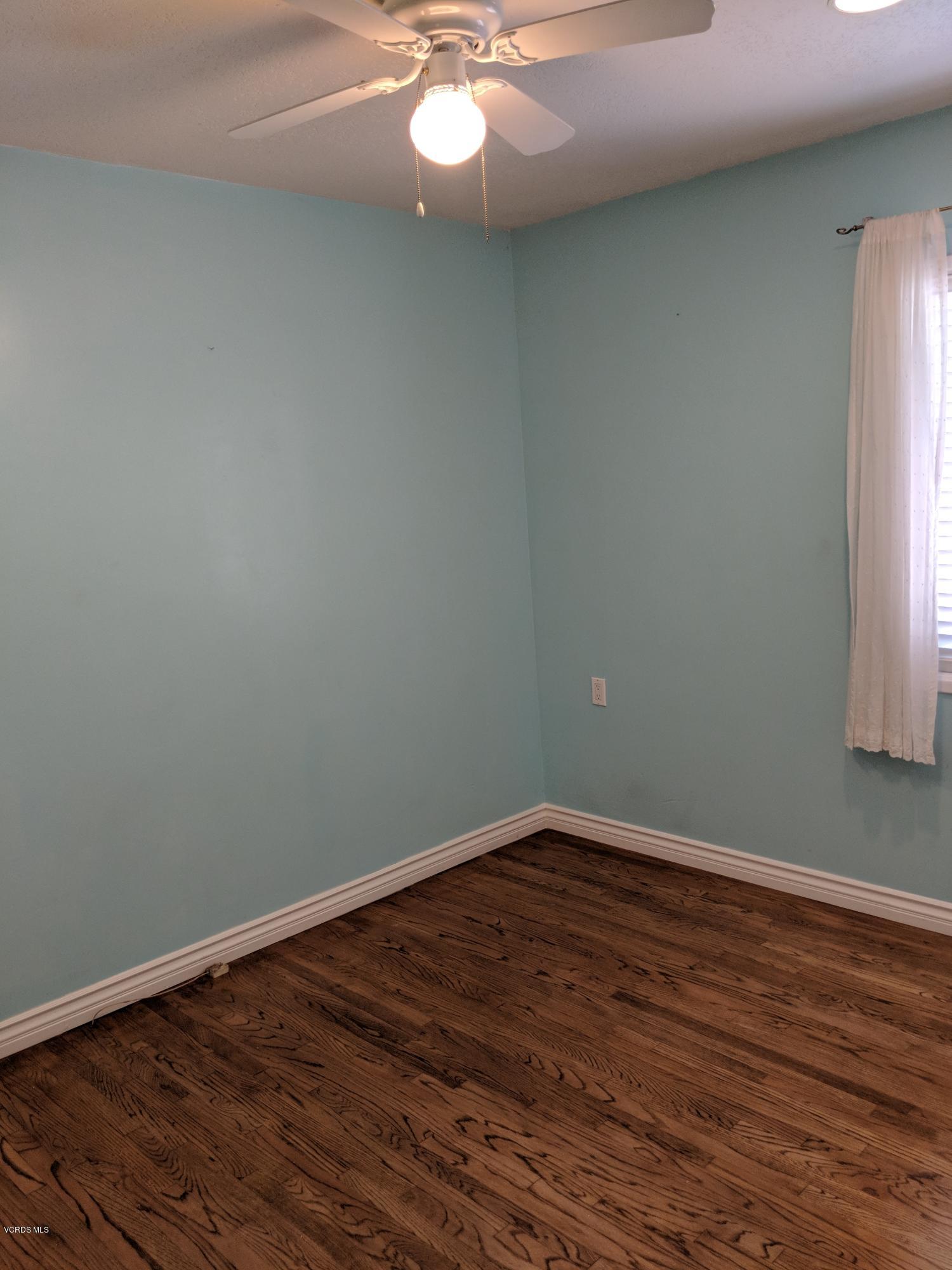 19518 Hart Street Reseda, CA 91335 - Photo 16 of 16 an empty room with wooden floor and windows