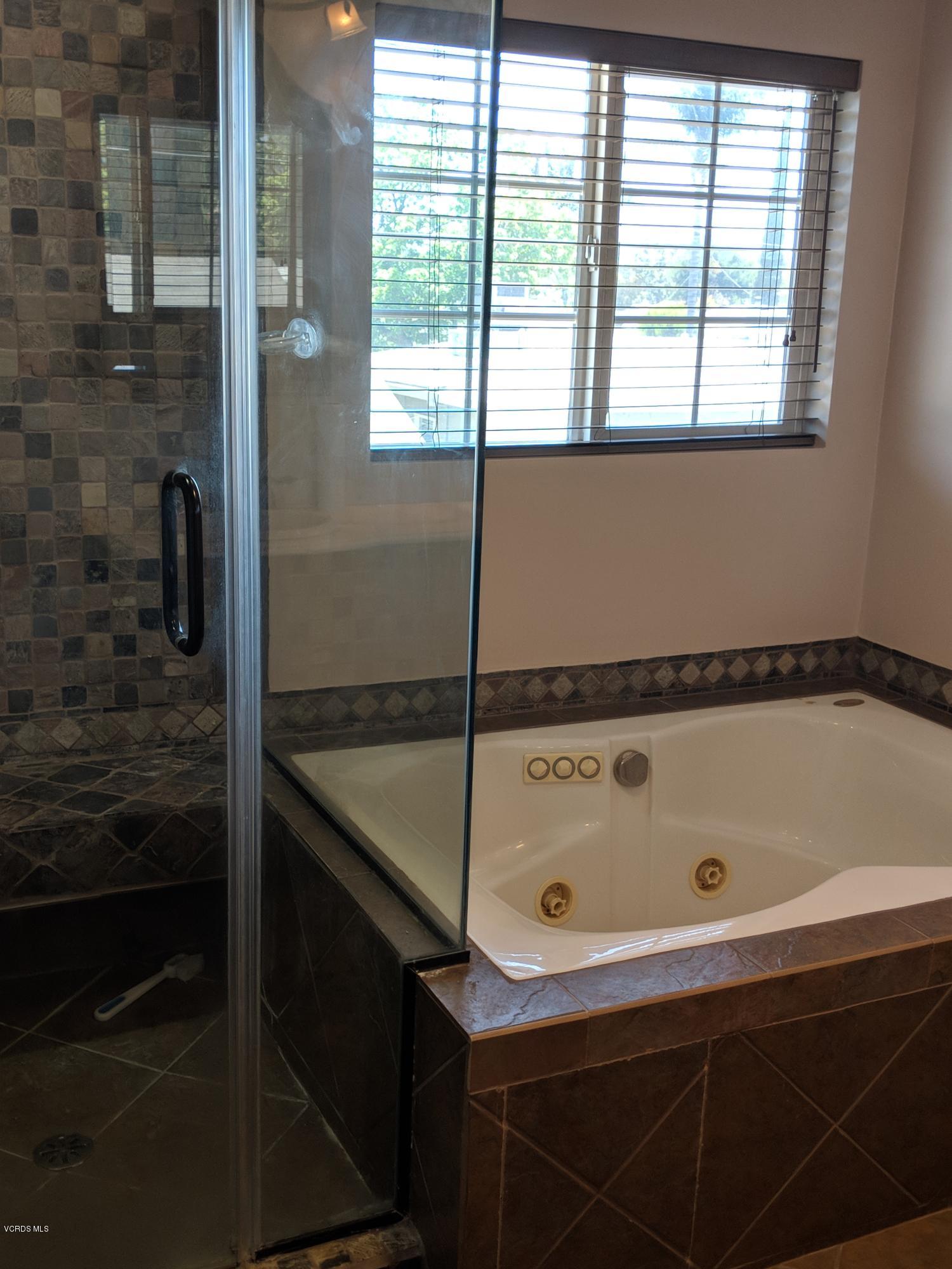 19518 Hart Street Reseda, CA 91335 - Photo 5 of 16 a bathroom with a tub and a shower