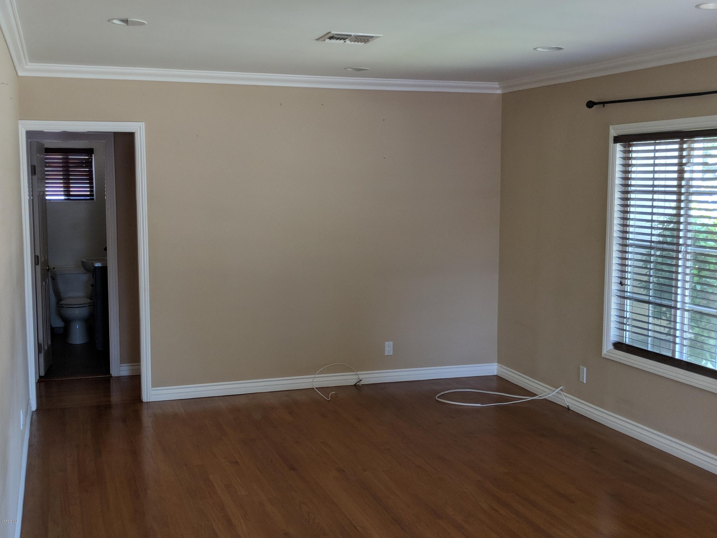 19518 Hart Street Reseda, CA 91335 - Photo 7 of 16 a view of a room with wooden floor and white walls