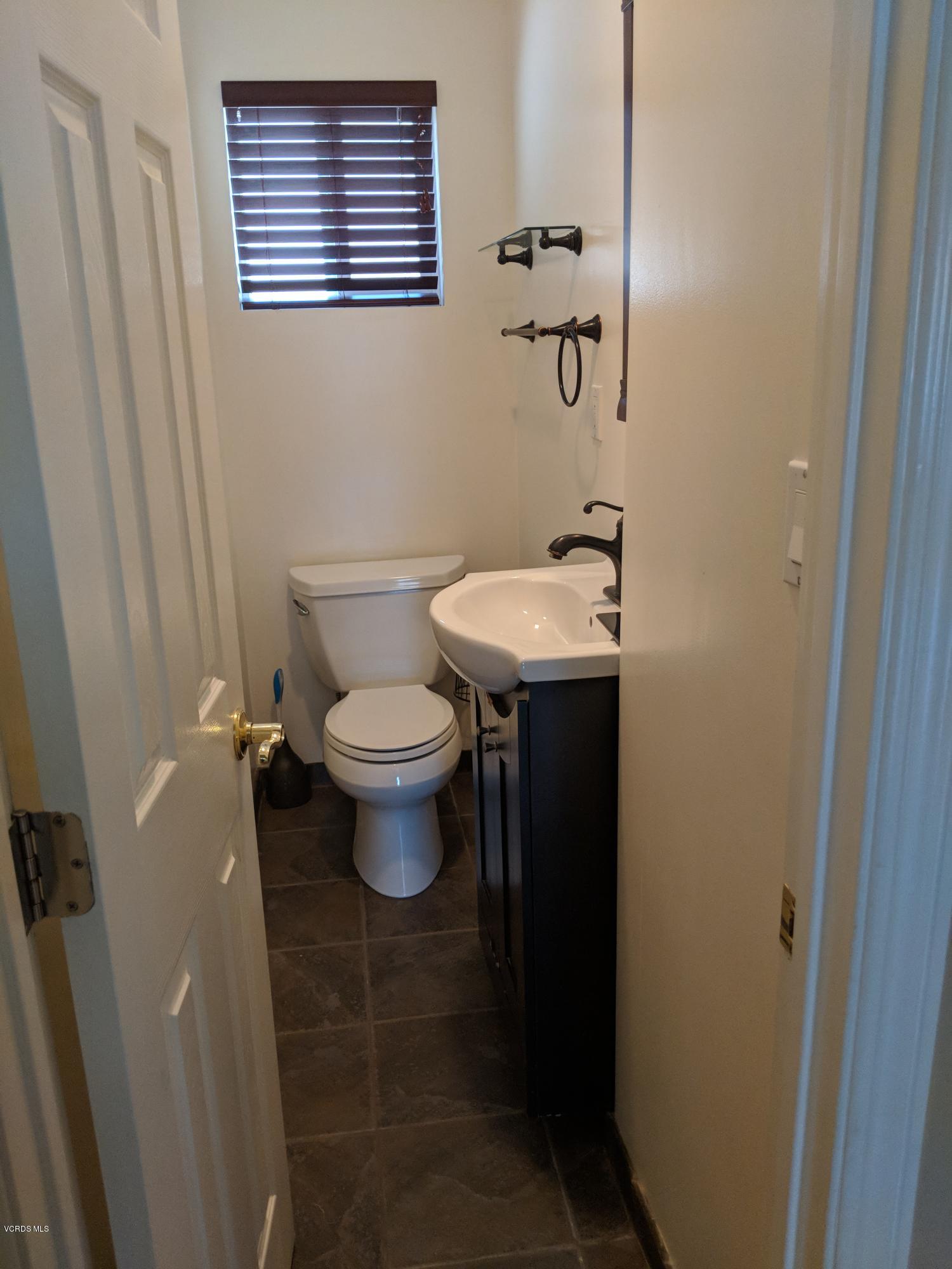 19518 Hart Street Reseda, CA 91335 - Photo 9 of 16 a bathroom with a sink and a toilet